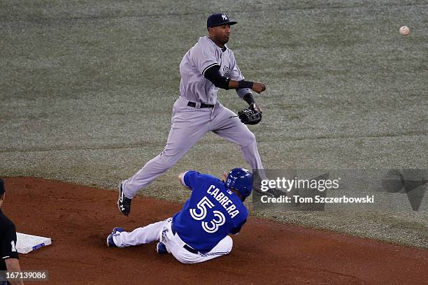 Eduardo Nunez of the New York Yankees commits a throwing error in the first inning after forcing out Melky Cabrera of the Toronto Blue Jays at second...