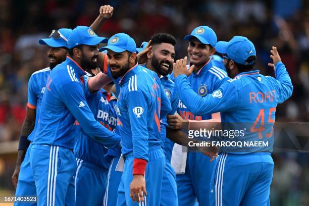 India's Mohammed Siraj celebrates with teammates after taking the wicket of Sri Lanka's captain Dasun Shanaka during the Asia Cup 2023 final one-day...