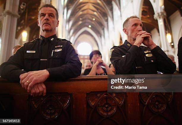 Boston Police Department Superintendents William Evans and Kevin Buckley attend Mass at the Cathedral of the Holy Cross on the first Sunday after the...