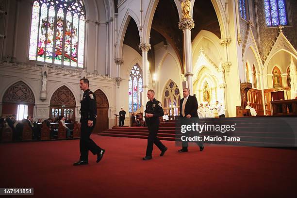 Boston Police Commissioner Edward Davis walks with Boston Police Department Superintendents William Evans , Kevin Buckley during Mass at the...