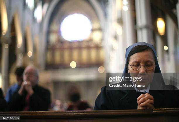 Nun worships during Mass at the Cathedral of the Holy Cross on the first Sunday after the Boston Marathon bombings on April 21, 2013 in Boston,...