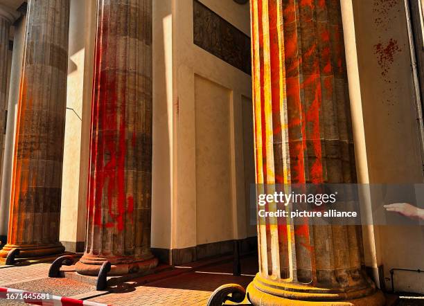 September 2023, Berln, Berlin: The pillars of the Brandenburg Gate, which members of the climate protection group Last Generation sprayed with orange...