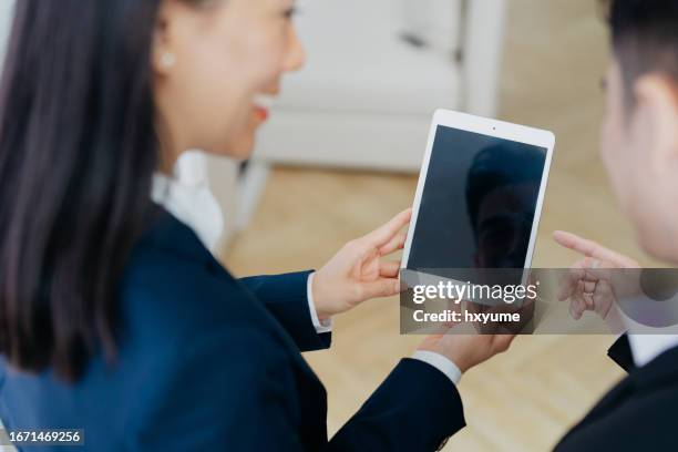 asian business people using digital tablet in office - ipad over shoulder stock pictures, royalty-free photos & images
