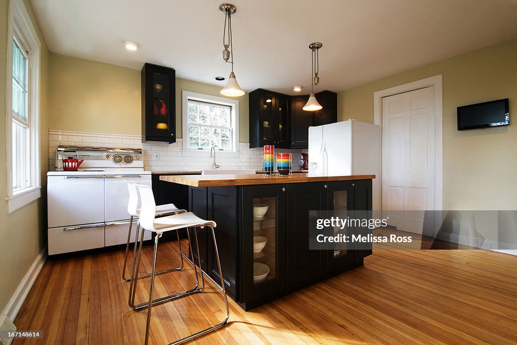 Modern residential kitchen with dark cabinets