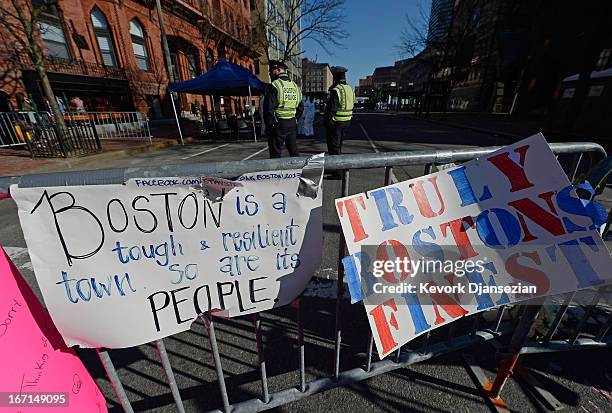 Signs are placed at a makeshift memorial for victims near the finish line of the Boston Marathon bombings two days after the second suspect was...