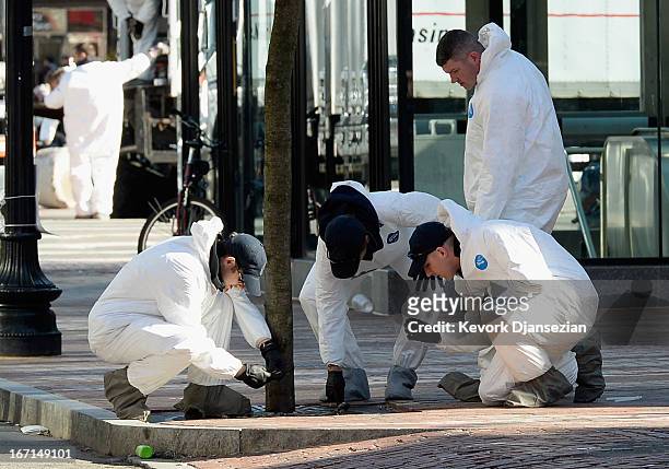 Law enforcement investigators work near the finsh line of the Boston Marathon on Boylston Street looking for evidence after last Monday's bombings...
