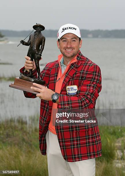 Graeme McDowell of Northern Ireland poses with the trophy after defeating Webb Simpson in a playoff during the final round of the RBC Heritage at...