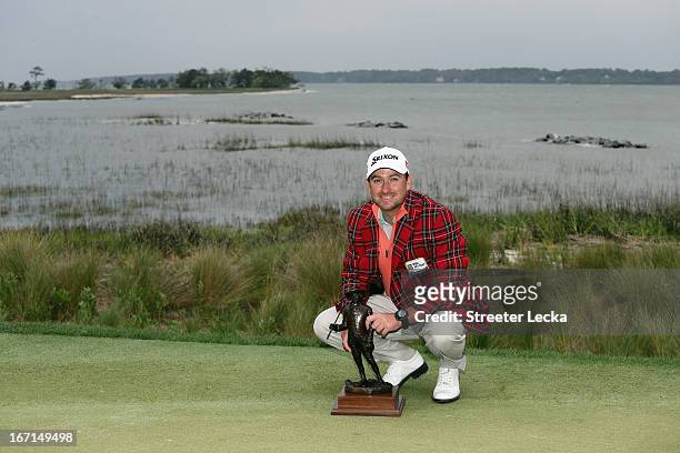 Graeme McDowell of Northern Ireland poses with the trophy after defeating Webb Simpson in a playoff during the final round of the RBC Heritage at...