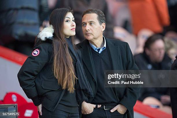 Eric Besson and Yasmine Tordjman are seen during the Ligue 1 match between Paris Saint Germain and OGC Nice at Parc des Princes on April 21, 2013 in...