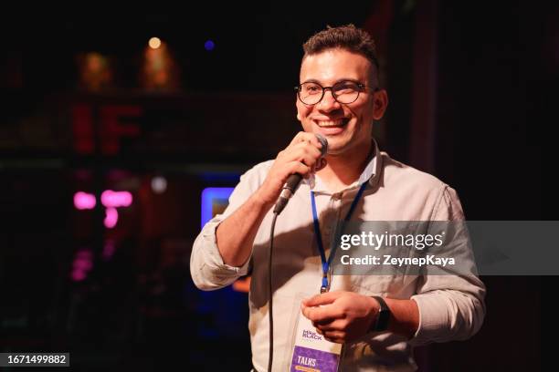 speeker hablando y mostrando una presentación a la audiencia en el escenario con micrófono - orador fotografías e imágenes de stock
