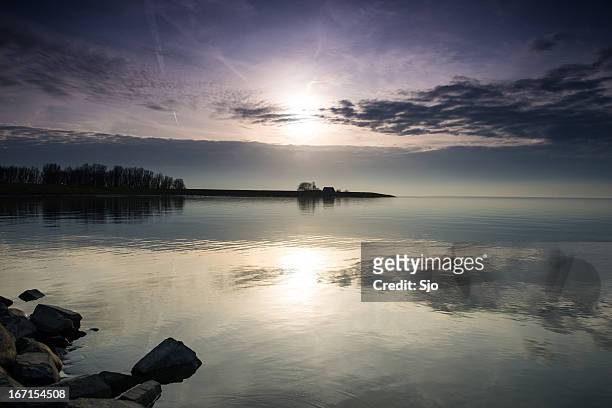 sunset at a lake - ijsselmeer stock pictures, royalty-free photos & images