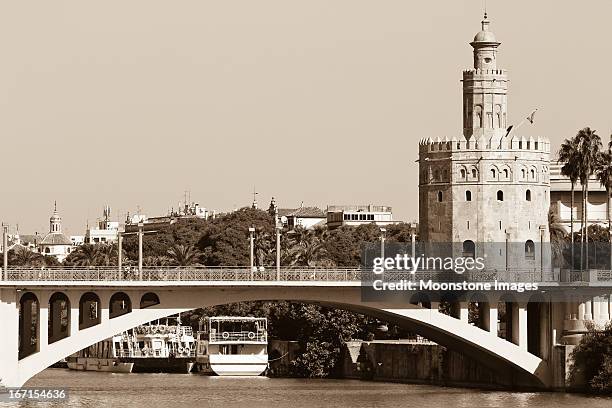 puenta de san telmo in seville, spain - torre del oro stock pictures, royalty-free photos & images