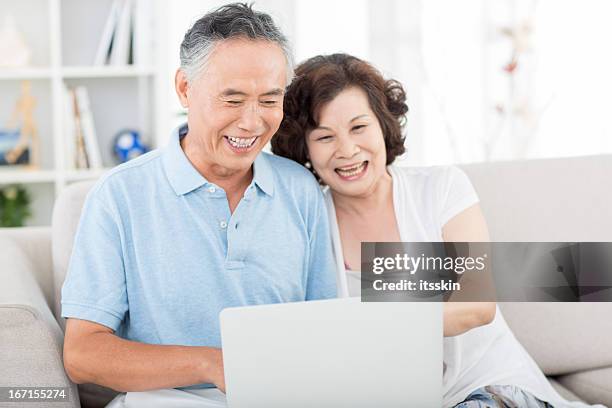 two senior asian people using computer - japanese senior couple bildbanksfoton och bilder