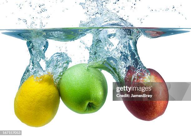 fresh apples and lemon splash into cool water - explosion of apples stock pictures, royalty-free photos & images