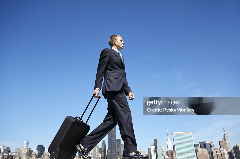 Traveling Businessman Walking with Suitcase Across City Skyline
