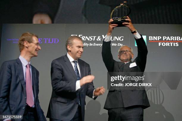 Of Taminco Pol Vanderhaegen holds the award as outgoing Belgian Prime Minister Yves Leterme applauds, as his company won the 15th edition of the...