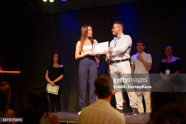 award certificate ceremony on stage - lgbt awards stockfoto's en -beelden