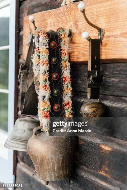 big and small bavarian cow bell on a wooden wall - anna bell peaks stock pictures, royalty-free photos & images