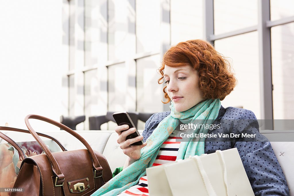 Woman sitting down checking messages.