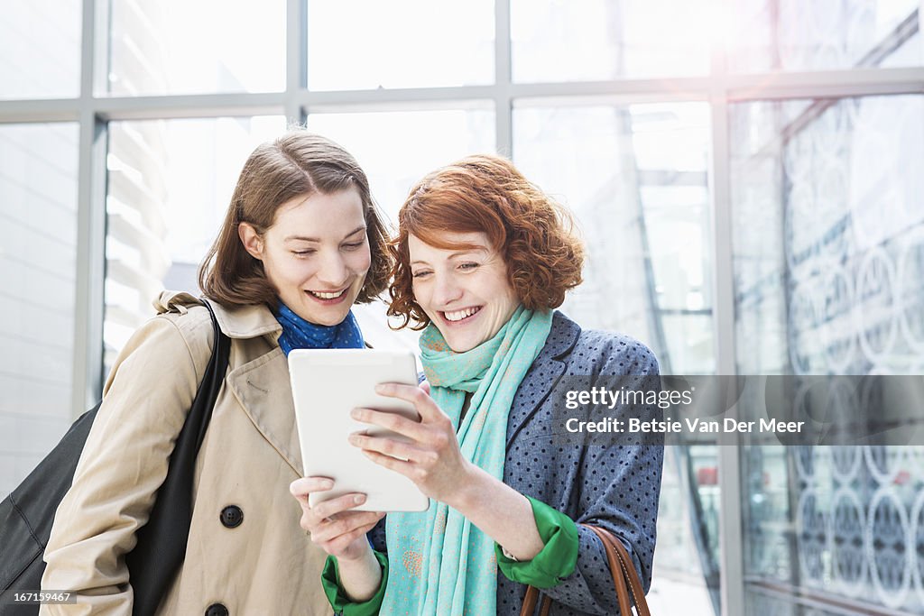 Women looking at digital tablet.