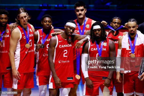Canada players pose with their bronze medals after the FIBA Basketball World Cup 3rd Place game victory over the United States at Mall of Asia Arena...