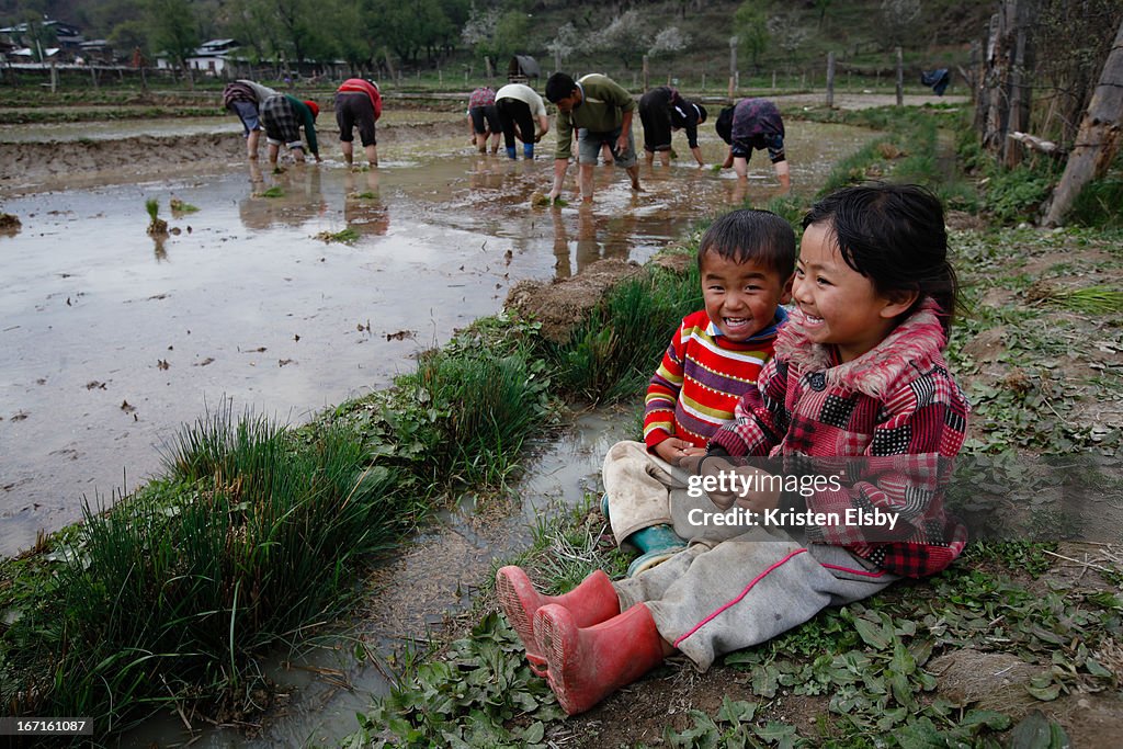 Bhutanese children laugh amongst the rice paddies