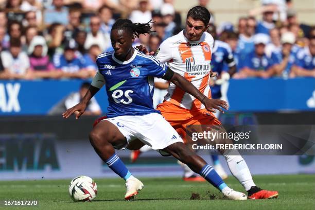 Strasbourg's French defender Ismael Doukoure fights for the ball with Montpellier's French midfielder Joris Chotard during the French L1 football...