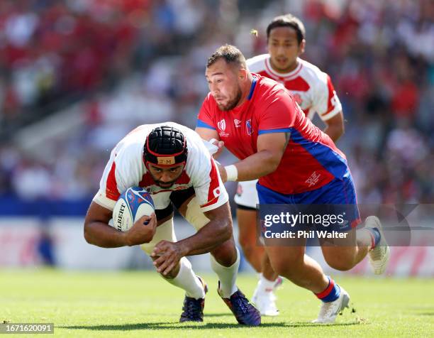 Michael Leitch of Japan is tackled by Javier Carrasco of Chile during the Rugby World Cup France 2023 match between Japan and Chile at Stadium de...