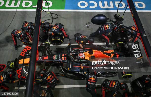Mechanics work on the car of Red Bull Racing's Dutch driver Max Verstappen in the pit lane during the Singapore Formula One Grand Prix night race at...