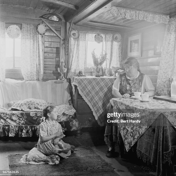 Romany woman and girl in their caravan on an encampment at Corke's Meadow in Kent, July 1951. Original publication: Picture Post - 5363 - The...