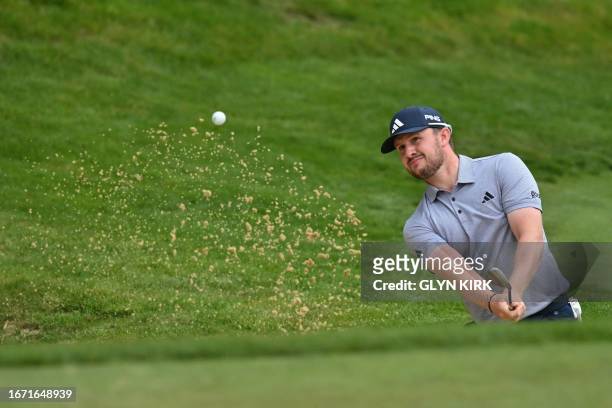 Scotland's Connor Syme plays from a green-side bunker on the 3rd hole on day four of the BMW PGA Championship at Wentworth Golf Club, south-west of...