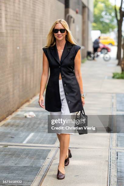 Lisa Aiken wears black sleeveless button up top, white shorts outside Tibi on September 09, 2023 in New York City.