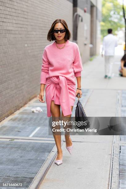 Aimee Song wears pink cashmere jumper, skirt outside Tibi on September 09, 2023 in New York City.