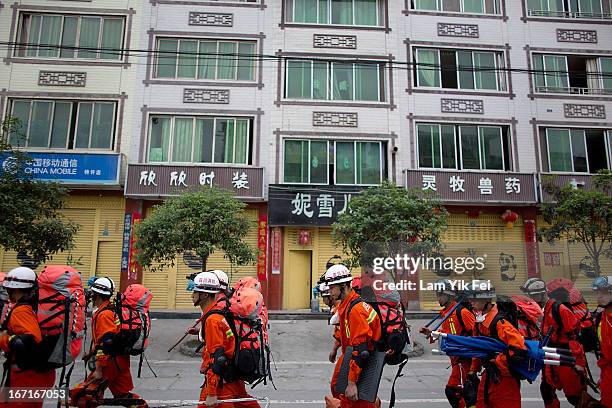 Rescue workers walk to BaoXing county, one of the hardest hit areas of the earthquake zone, on April 21, 2013 in China. A powerful earthquake struck...