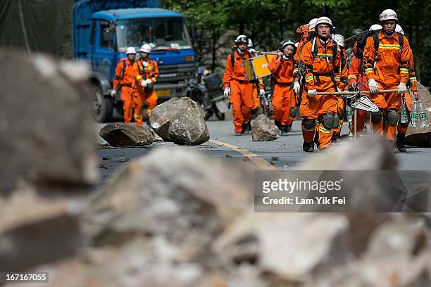 Rescue workers walk to BaoXing county, one of the hardest hit areas of the earthquake zone, on April 21, 2013 in China. A powerful earthquake struck...