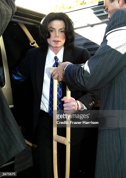 Singer Michael Jackson arrives at the Santa Maria Superior Court on crutches for an early morning court appearance on December 4, 2002 in Santa...