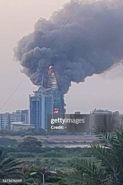 This picture taken on September 17, 2023 shows a raging fire at the Greater Nile Petroleum Oil Company Tower in Khartoum. Battles between the regular...