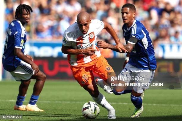 Montpellier's French forward Wahbi Khazri fights for the ball with Strasbourg's Brazilian forward Angelo Gabriel during the French L1 football match...