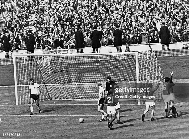 The England team celebrate after Geoff Hurst scores the controversial third goal against West Germany during the World Cup final at Wembley Stadium,...