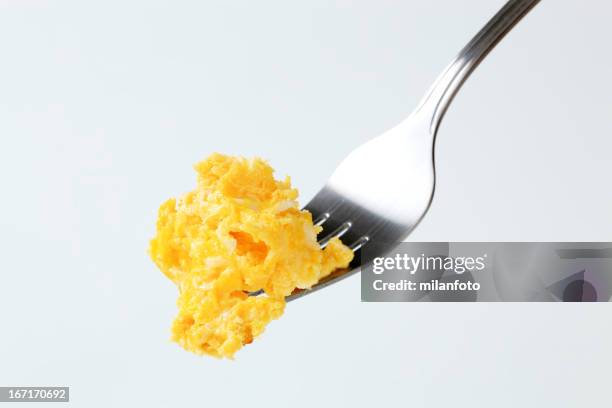 scrambled eggs on a fork - roerei stockfoto's en -beelden