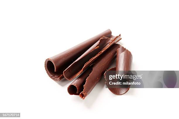 chocolate shavings laying on a white background - chocolate shaving stock pictures, royalty-free photos & images
