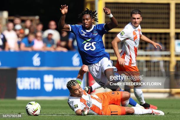 Strasbourg's Ivorian forward Moise Sahi fights for the ball with Montpellier's French midfielder Teji Savanier during the French L1 football match...