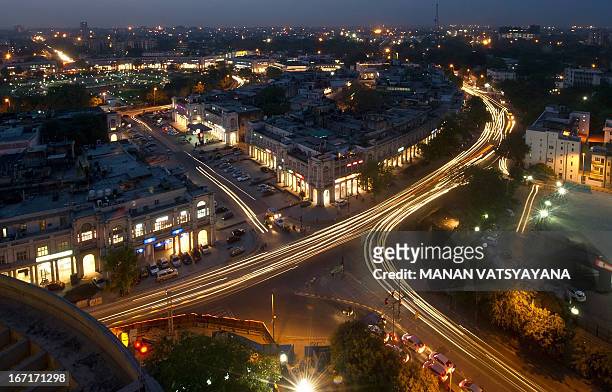 This photograph taken on April 18, 2013 shows the Indian capital's skyline as traffic drives around the outer circle of Connaught Place in the heart...