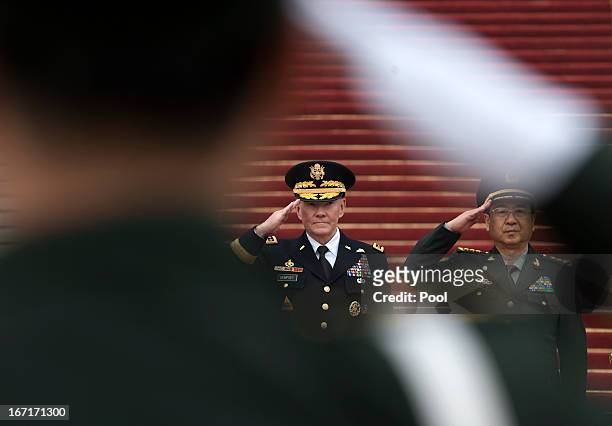 Joint Chiefs Chairman Gen. Martin Dempsey and Chinese counterpart Gen. Fang Fenghui salute during a welcoming ceremony at the Bayi Building on April...