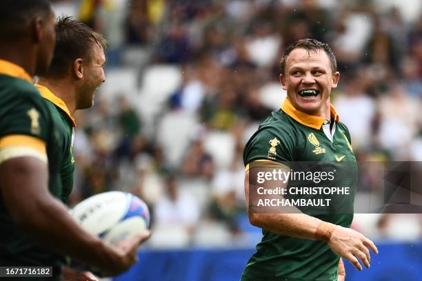 South Africa's hooker Deon Fourie celebrates with teammates after scoring the team's sixth try during the France 2023 Rugby World Cup Pool B match...