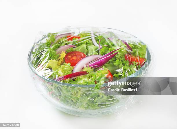 freshly prepared vegetable salad covered in plastic wrap - salad bowl stock pictures, royalty-free photos & images