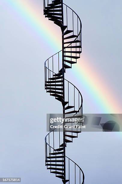 rainbow near spiral staircase - spiral staircase stock-fotos und bilder