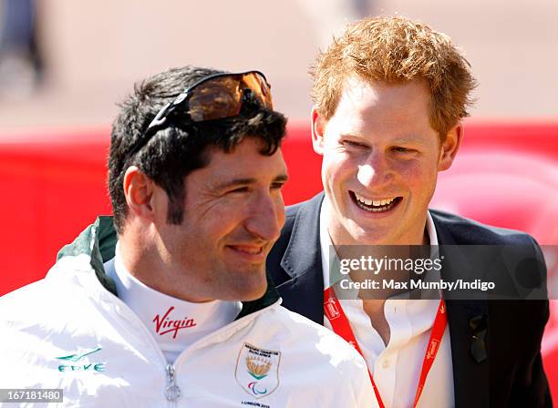 Ernst Van Dyk, who came third in men's wheelchair race and Prince Harry attend the prize giving ceremony at the Virgin London Marathon 2013 on April...