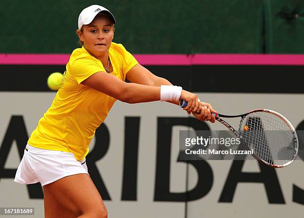 Ashleigh Barty of Australia plays a backhand against Stefanie Voegele of Switzerland during day three of the Fed Cup World Group Play-Offs between...