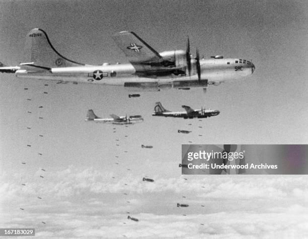 Boeing B-29 Superfortresses dropping bombs during a raid on a chemical plant in Koman-dong, Koman-dong, Korea, August 14, 1950.